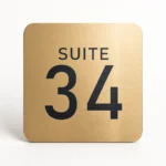 Custom door number sign in brushed gold acrylic with Suite 34 engraving