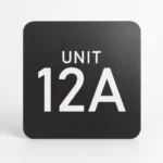 Custom door number sign in black with white engraving Suite 34